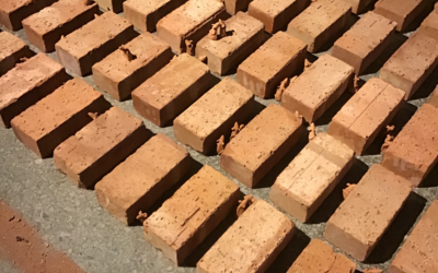 Red clay bricks laid out on the floor, interspersed with small clay mice. The Work was an art installation created by Rob Hopper in collaboration with the History & Cultures project. 